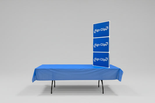 Sign Clip Display Table Tower on a table with a blue tablecloth.