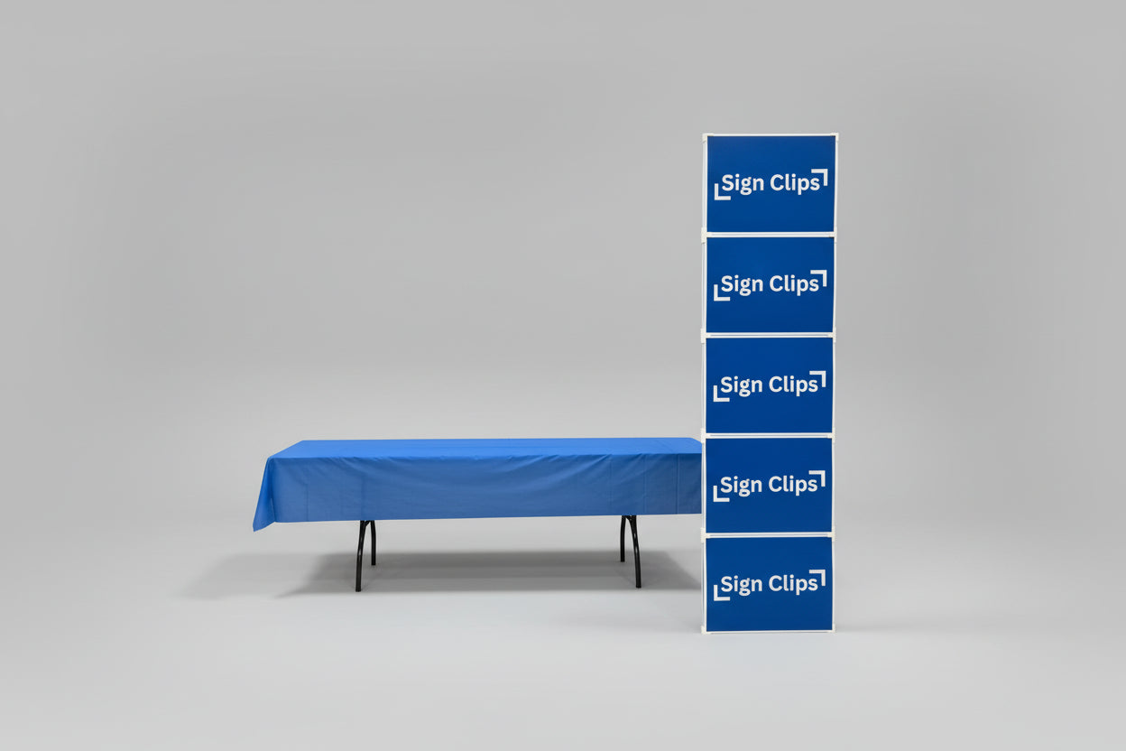Sign Clip Display Floor Tower next to a table with a blue tablecloth